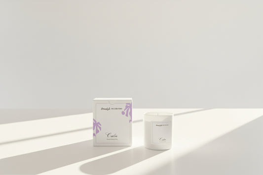 Candle and packaging with 'Homestyle Decorators' branding on a light background